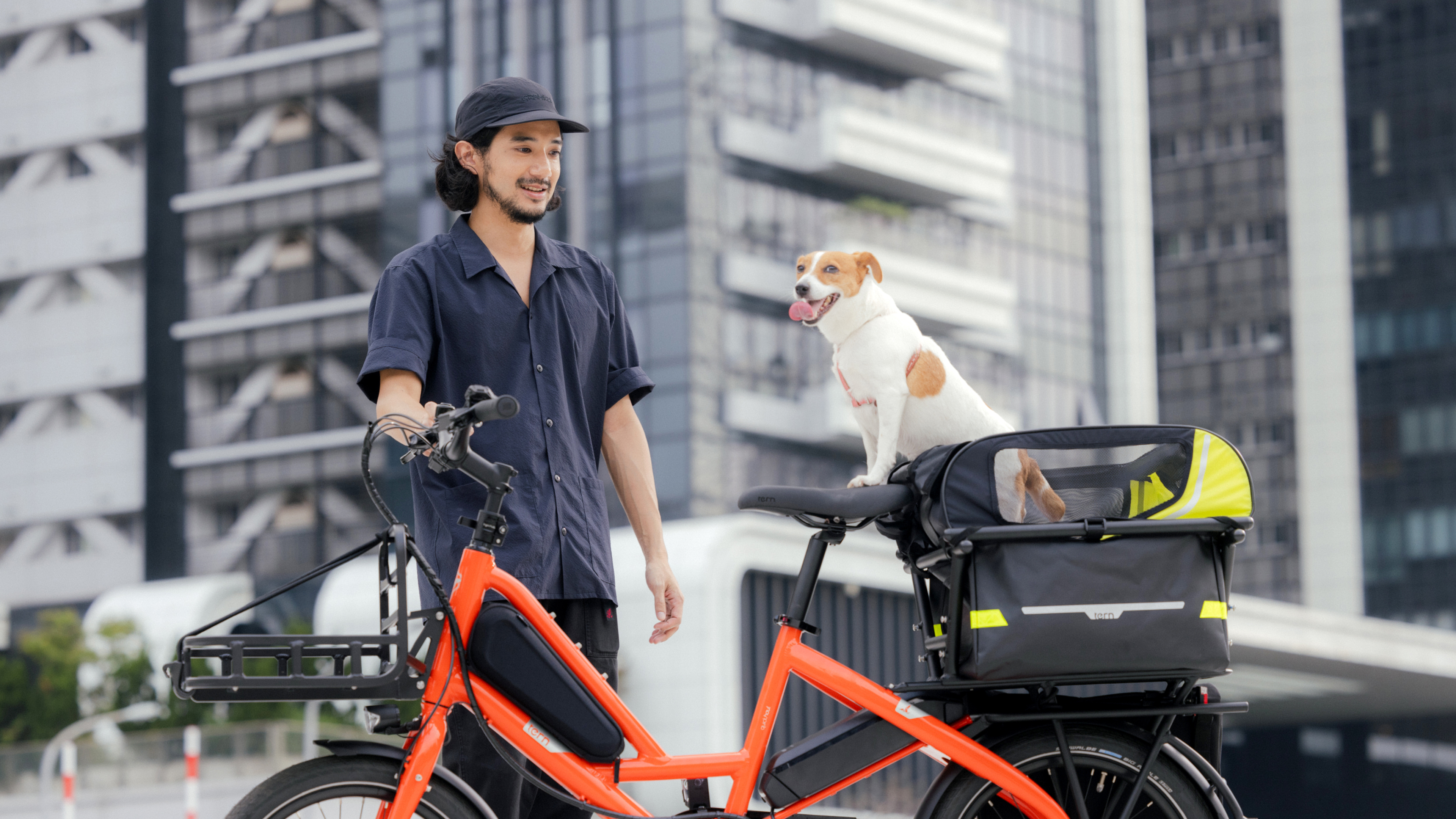 A man riding Quick Haul with the dog in the rear rack