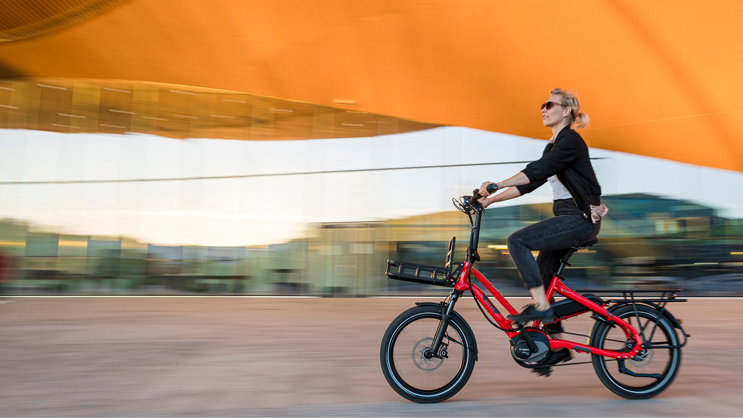 A woman riding on a red HSD
