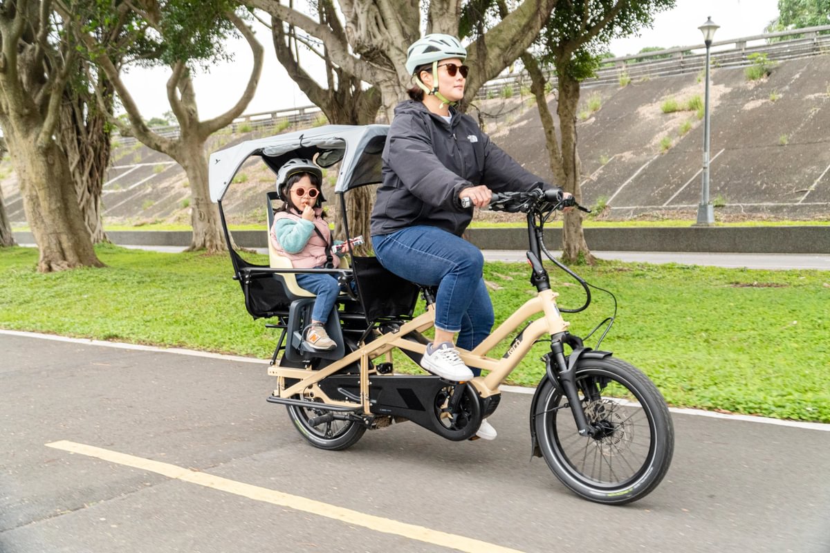GSD Gen 3 with mom rider carrying young kid in child seat, Clubhouse, and Sun Shield