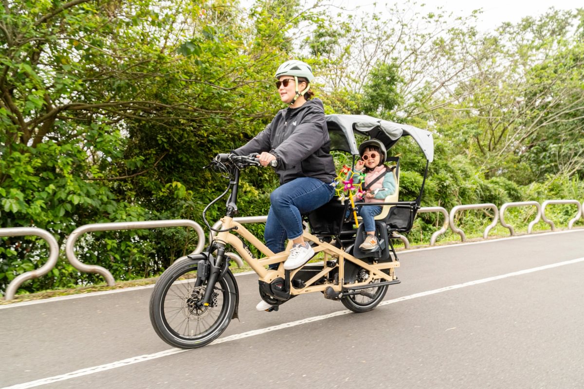 Mom and kid riding on GSD Gen 3, with Clubhouse, child seat, and Sun Shield