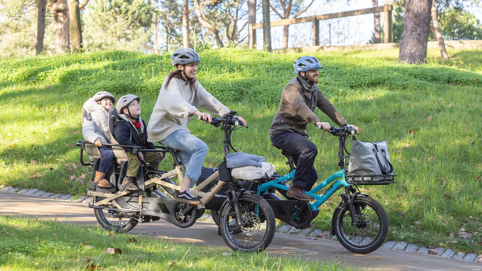 Family of four riding on two Tern GSD Gen 3 electric cargo bikes.