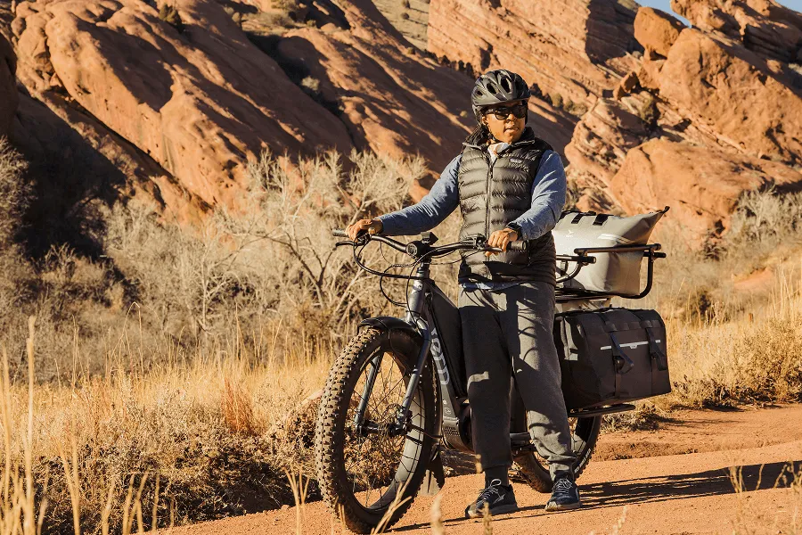 A man walks with the Orox bike