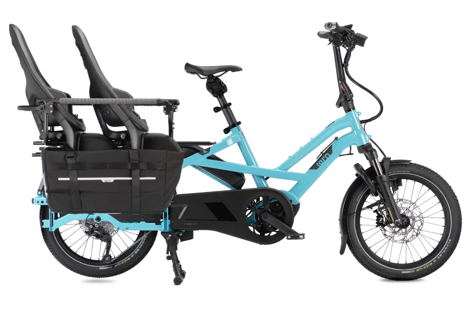 Tern GSD Gen 3 cargo ebike with two child seats inside the Clubhouse passenger carrier and the waterproof Cargo Hold 52 Panniers for foot and leg protection.
