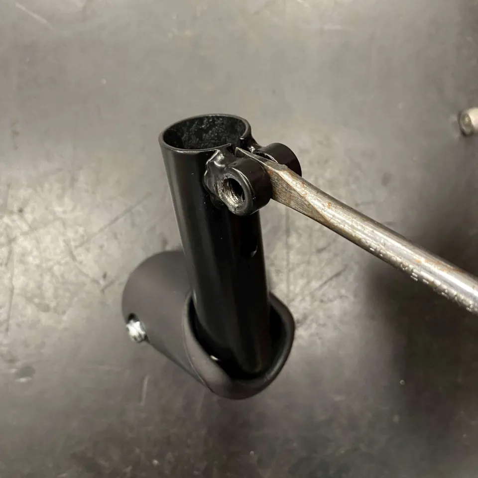 Step 3: Using a flathead screwdriver, carefully widen the gap on the DuoStand Ends and reinstall the locking screw without tightening it.