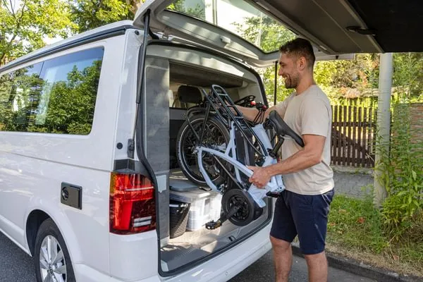 Tern Vektron Gen 4 folding electric bike being put in a car trunk