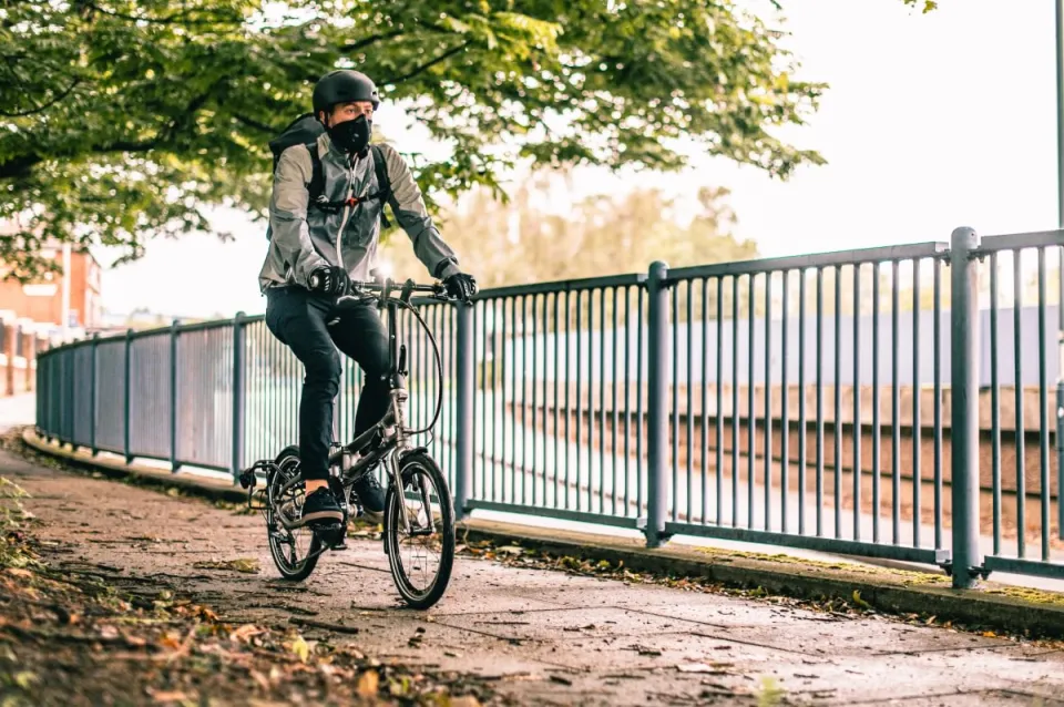 A commuter riding his Tern BYB folding bike with front lights installed.