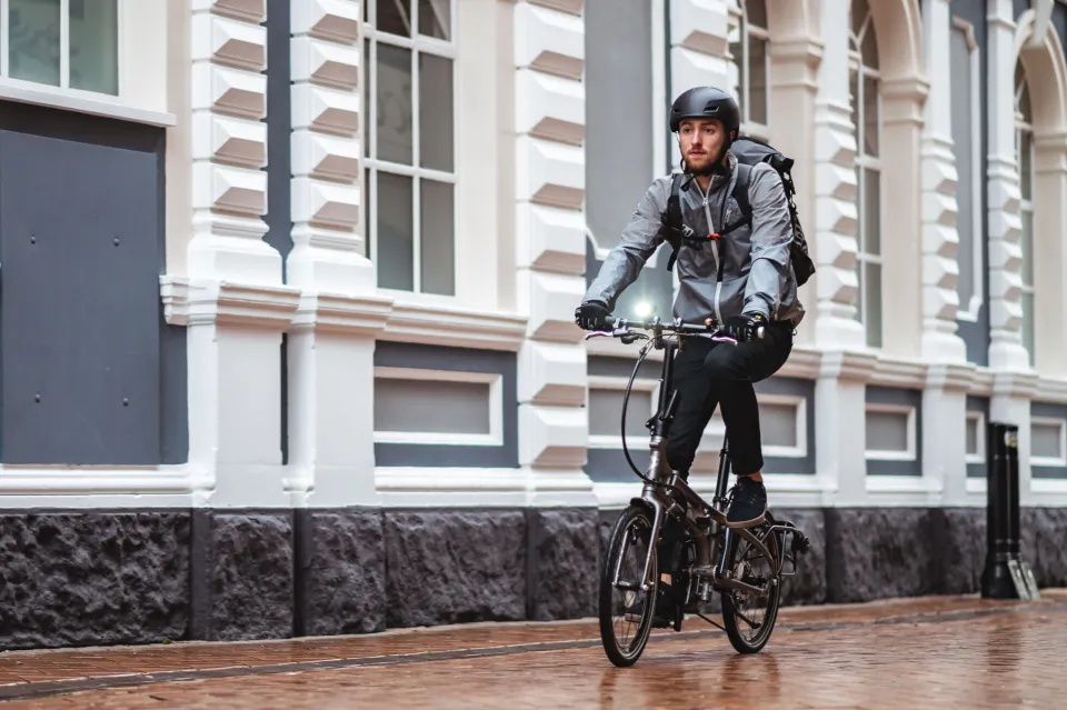 A commuter riding his Tern BYB folding bike with front lights installed.