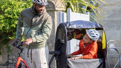 Banner image showing the Clubhouse Fort bike weather canopy for kids on a Tern Quick Haul Long cargo electric bike.