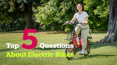 Article banner image showing the text "Top 5 Questions About Electric Bikes", with a woman riding the Tern NBD electric bike.