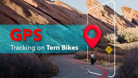 Woman riding a Tern Orox adventure cargo ebike in arid landscape