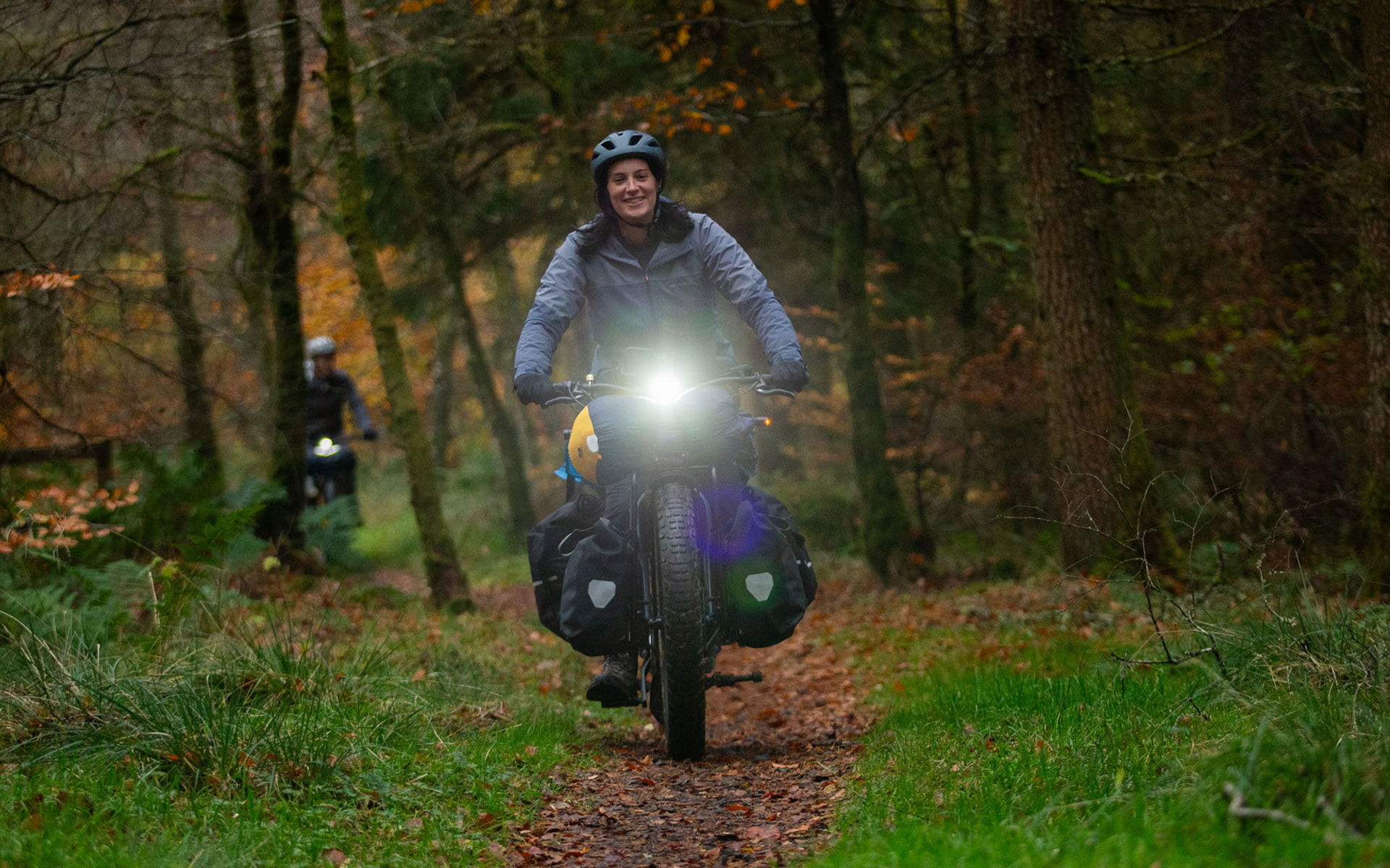 Bike with headlight on, riding in the forest
